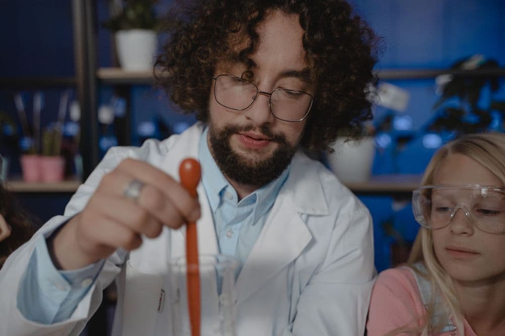 A teacher and student doing a chemistry experiment